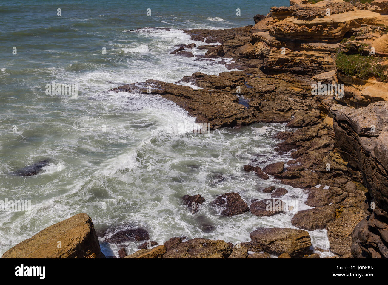view on coast line rocks in ocean with splash waves Stock Photo - Alamy