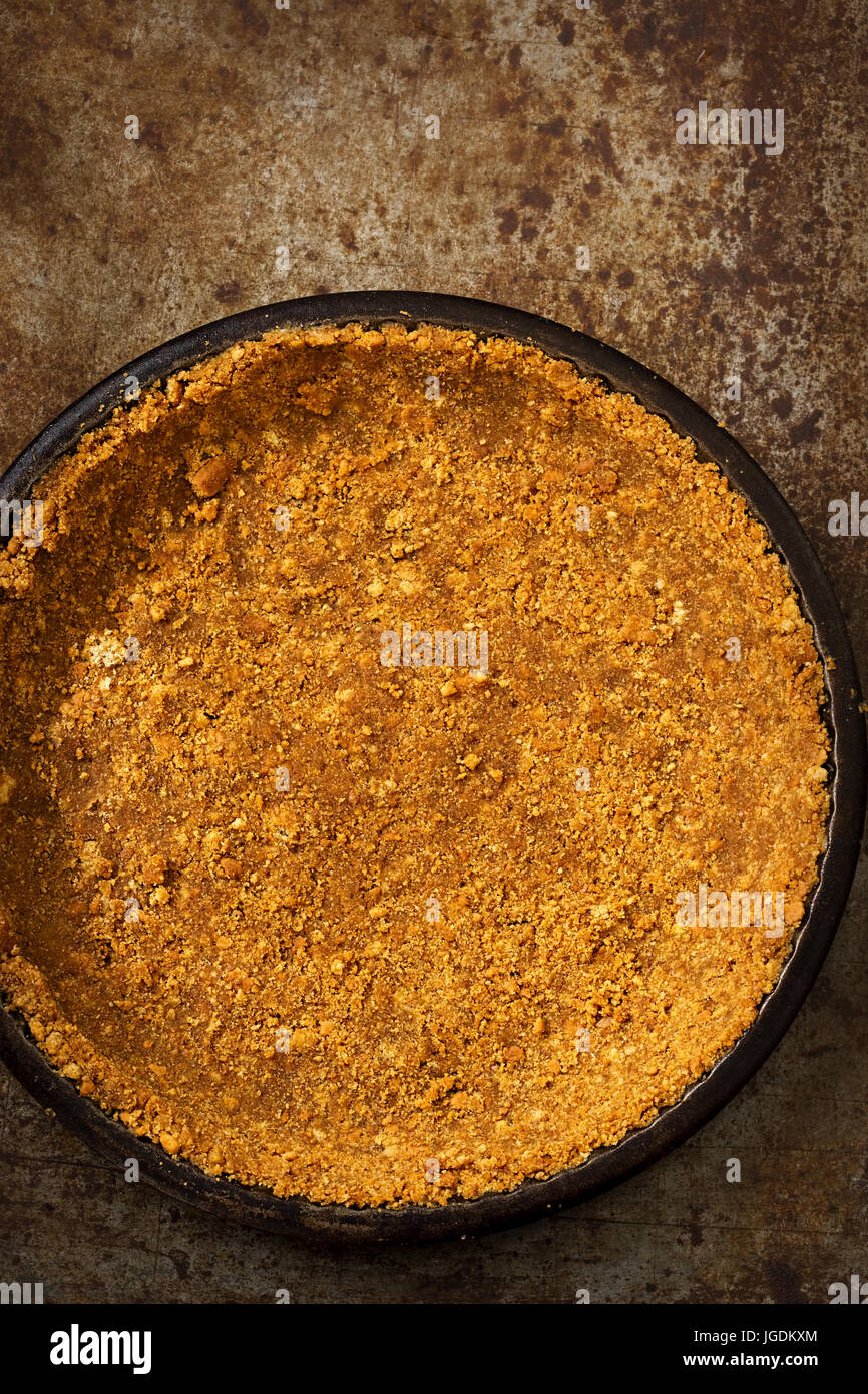 Baked pie base pastry made from crushed biscuits and butter in tart pan