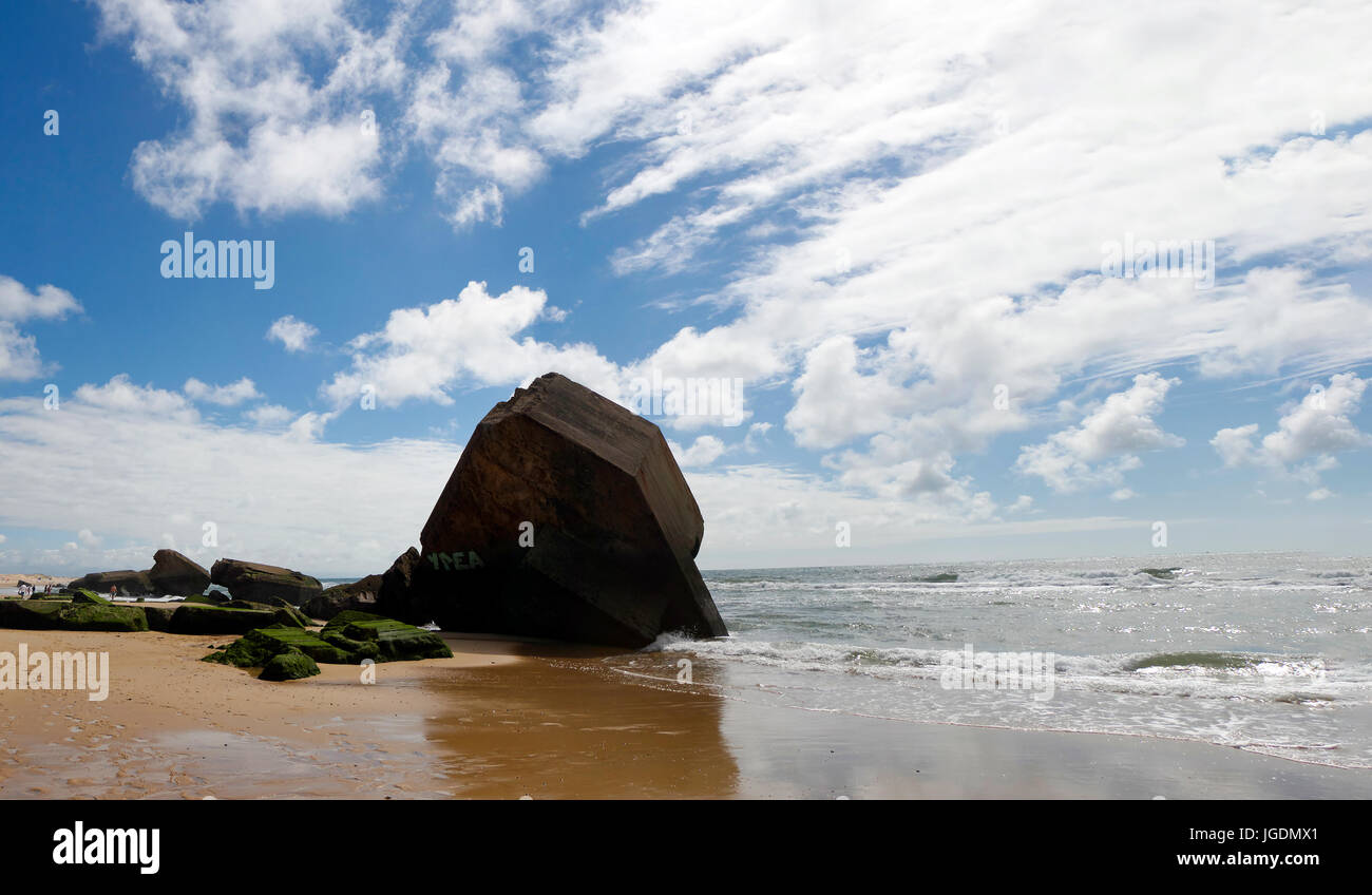 a blockhouse on the beach with blue sky and clouds Stock Photo