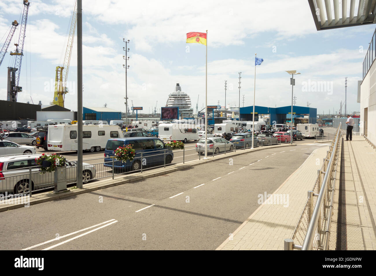 Cars and caravans lined up waiting to board a ferry in Portsmouth ferry port Stock Photo
