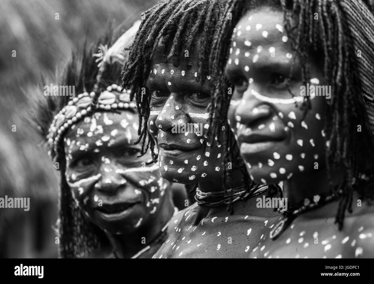 DANI VILLAGE, WAMENA, IRIAN JAYA, NEW GUINEA, INDONESIA – 15 MAY 2012: Portrait of Woman Dani tribe in ritual coloring on the body and face. Stock Photo