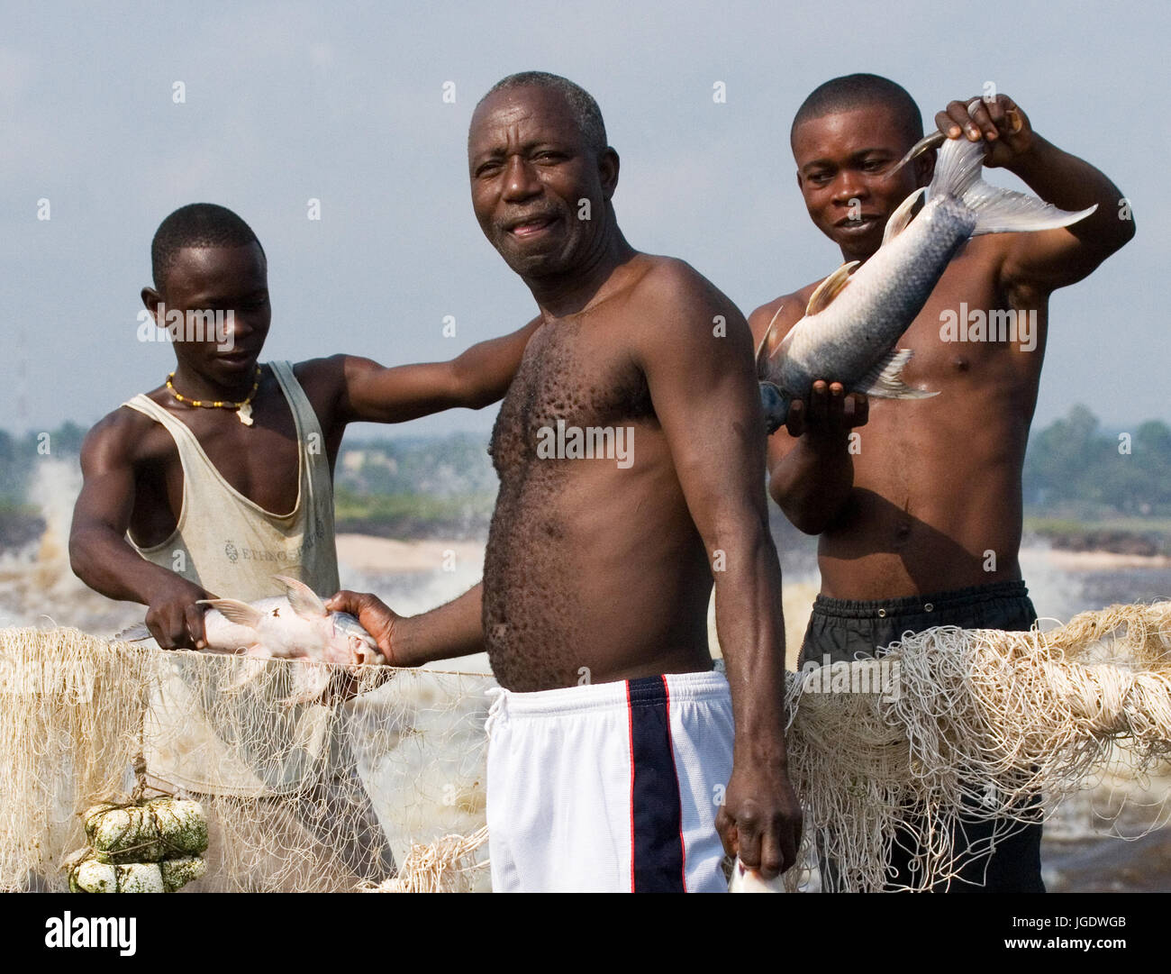 REPUBLIC OF CONGO, SUBURB OF BRAZZAVILLE - MAY 09, 2007: Fishermen with fish near Brazzaville. The rapids of the Congo River. Stock Photo