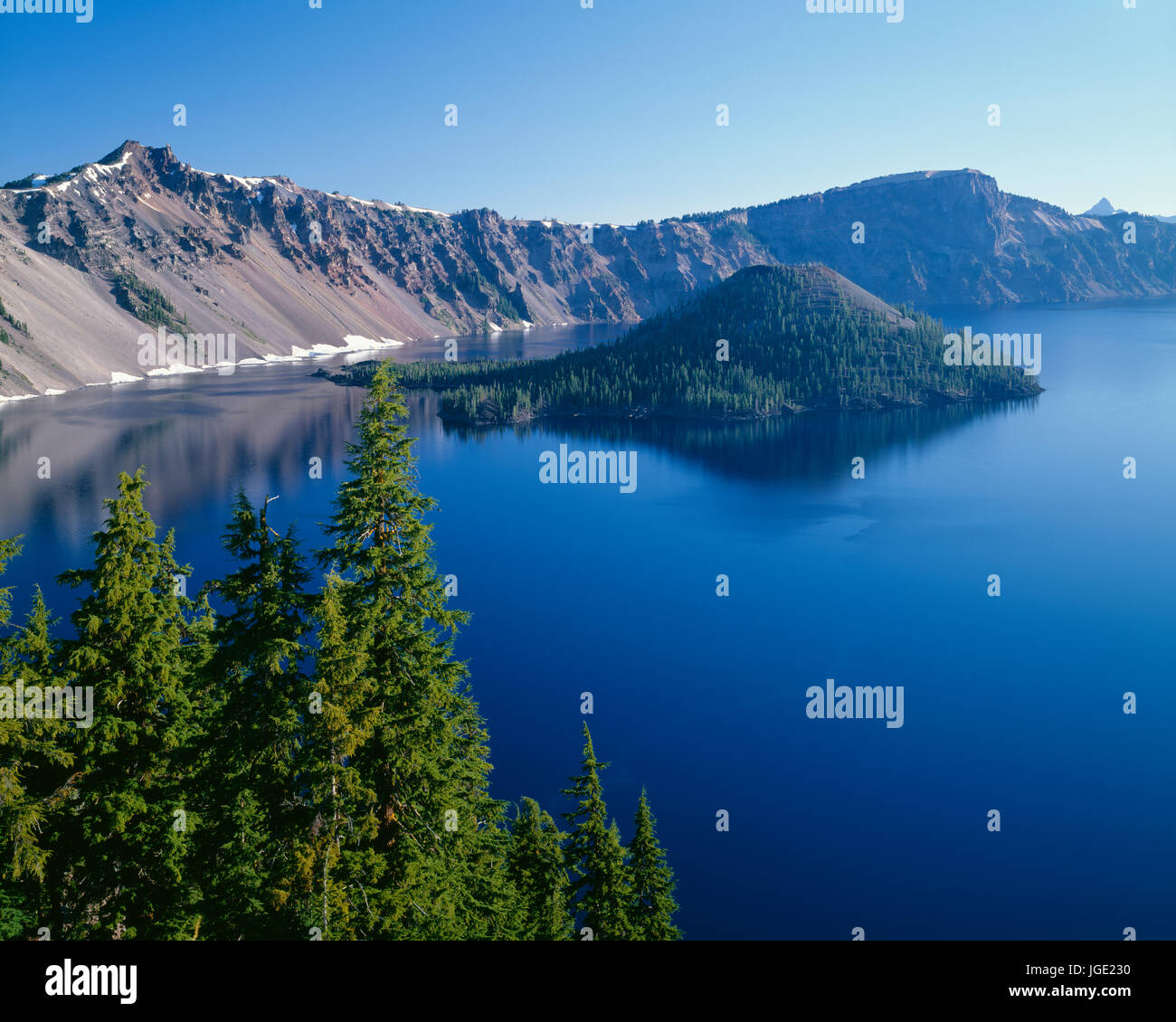 USA, Oregon, Crater Lake National Park, West rim of Crater Lake with Hillman Peak (left) and Llao Rock (right) overlooking Wizard Island. Stock Photo