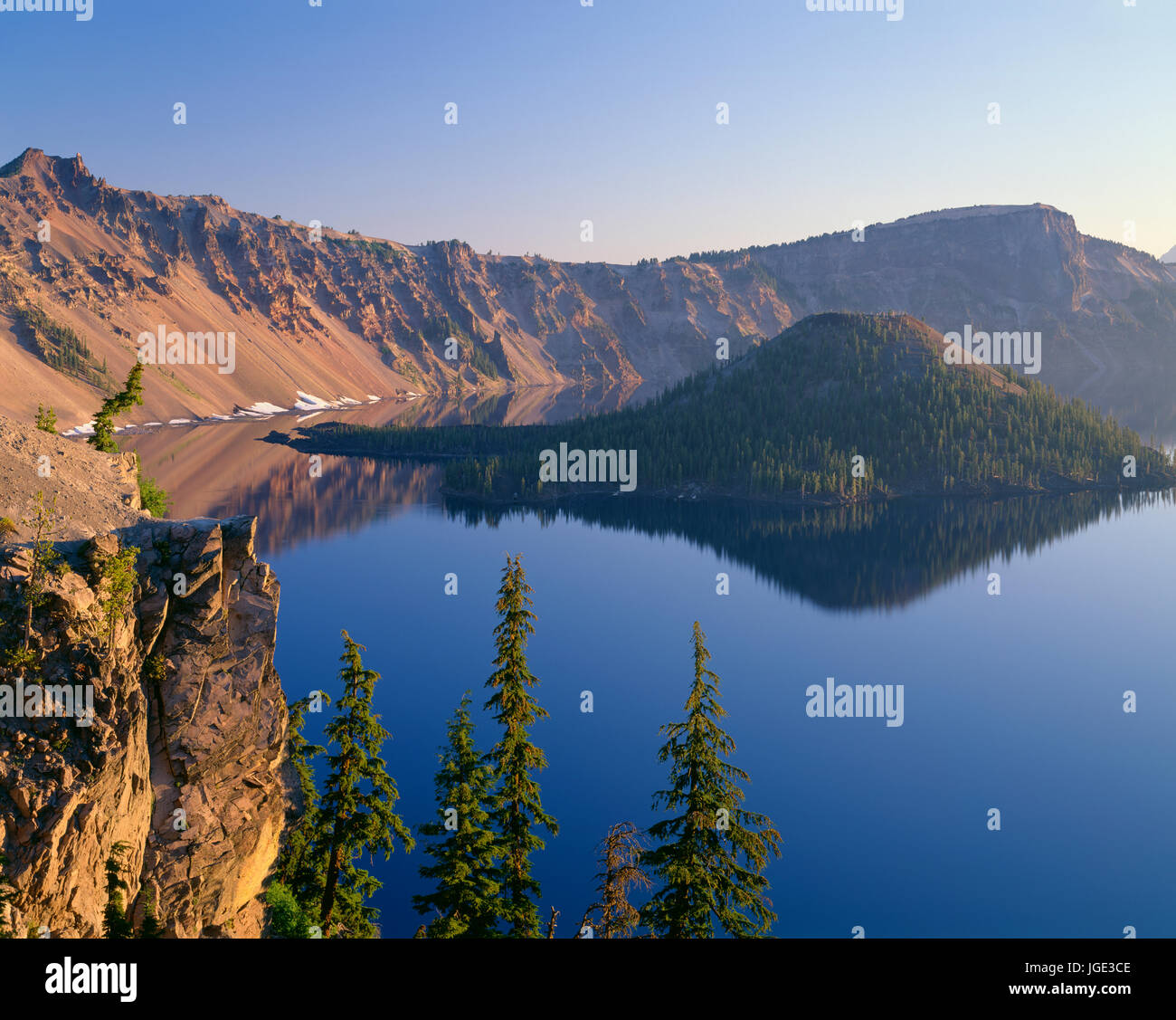 USA, Oregon, Crater Lake National Park, Sunrise glow on west rim of