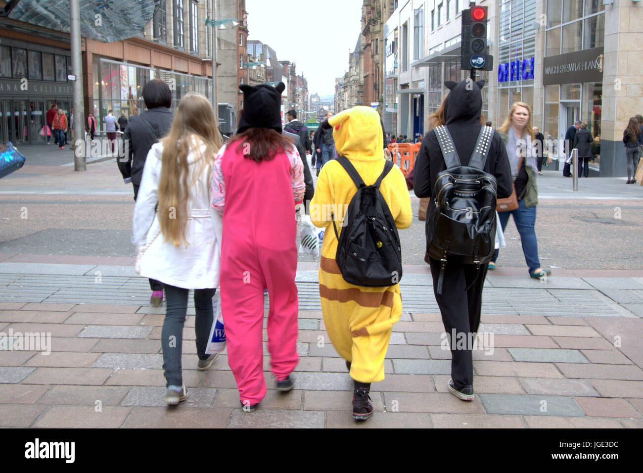 onesy fashion faux pas all in one outfit  four young girls teenagers onesies and loungewear onepiece on the street Stock Photo