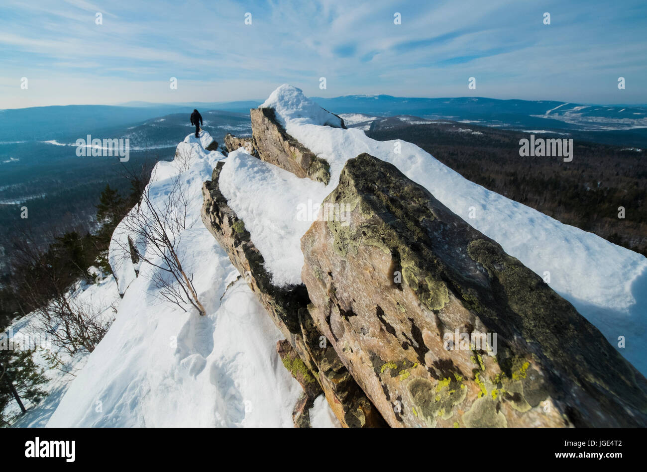 Caucasian man hiking on mountain in winter Stock Photo