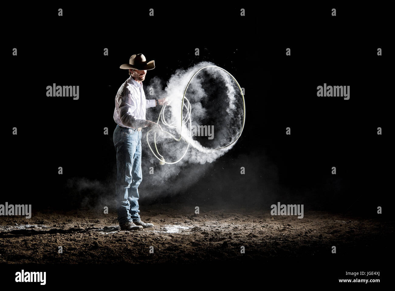 Caucasian cowboy spinning lasso Stock Photo