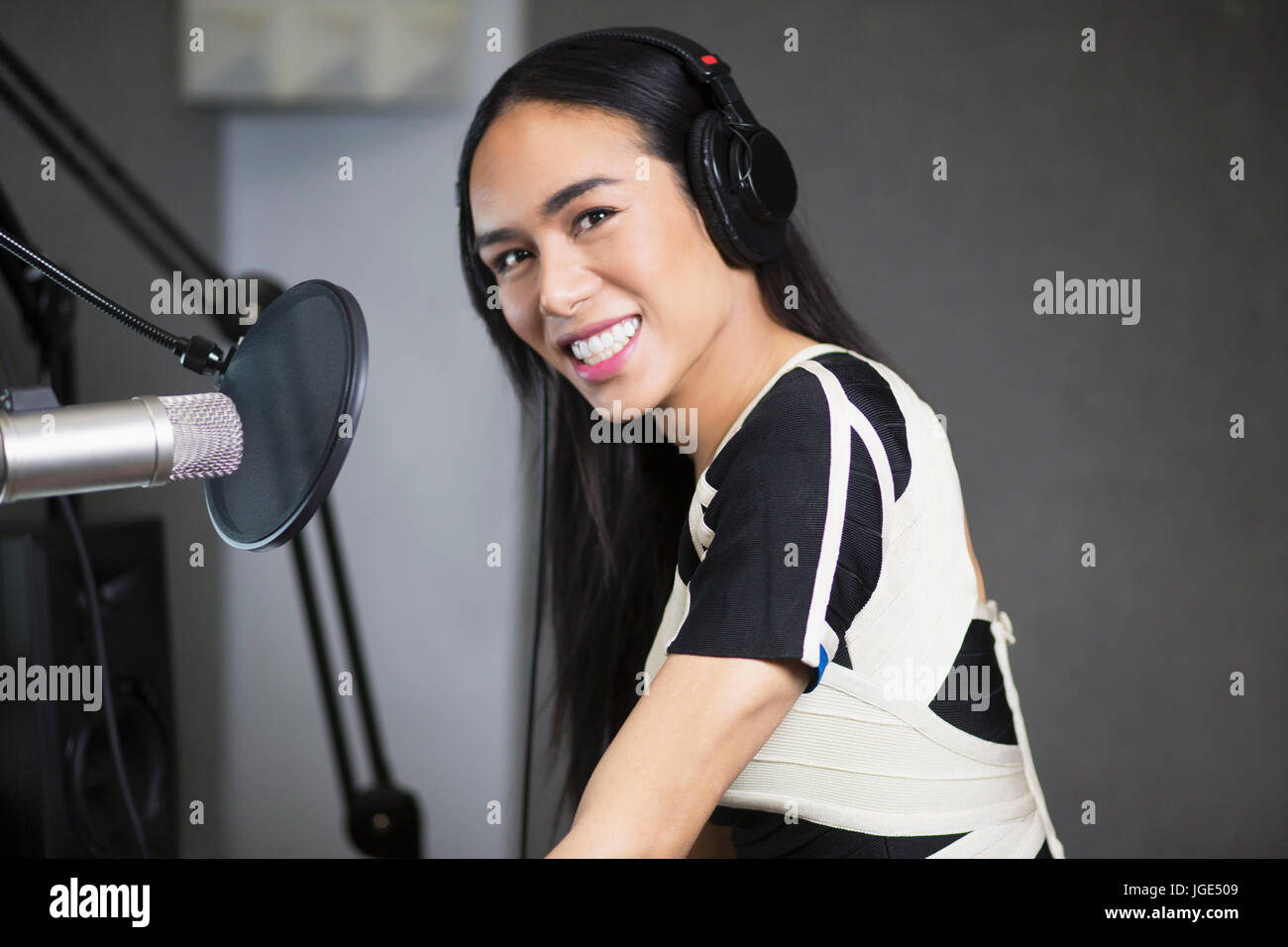 Smiling Thai transgender woman at microphone Stock Photo