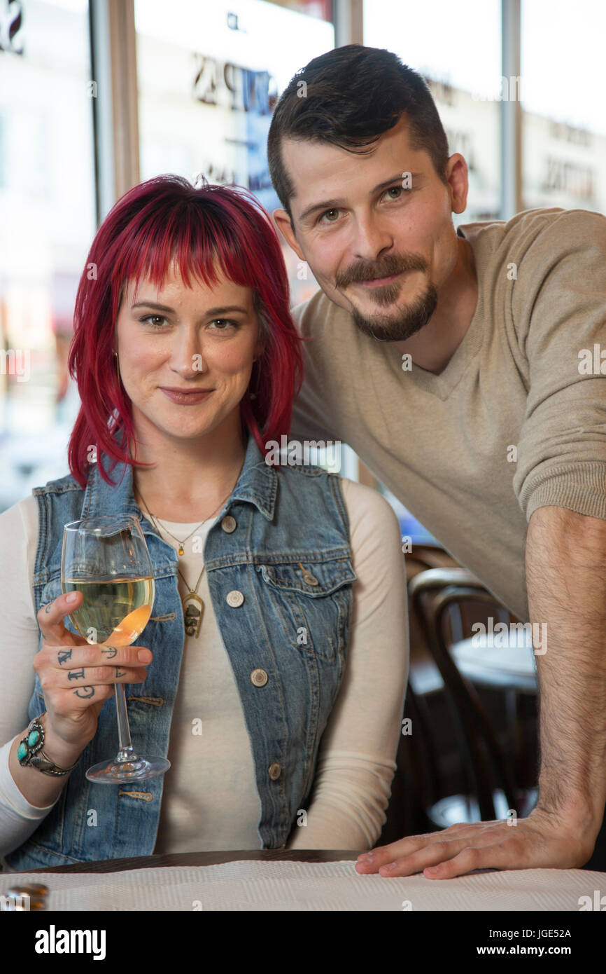 Portrait of Caucasian couple with white wine in restaurant Stock Photo