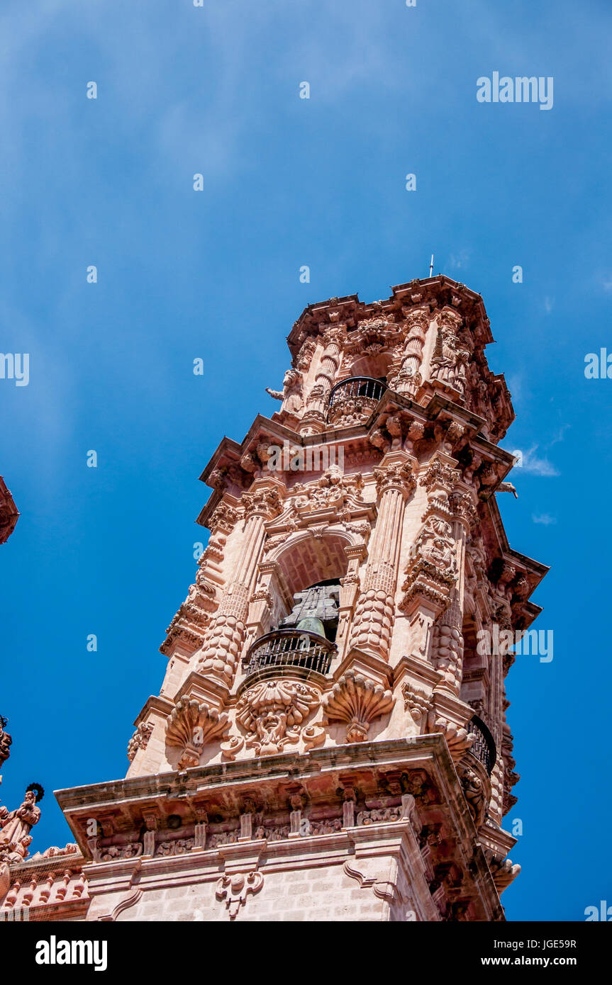 Baroque spire on the church of Santa Prisca, a monument in the town of Taxco de Alarcon in Mexico with its ornamentad exterior viewed low angle from b Stock Photo