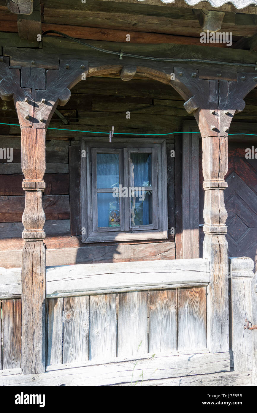 The detail of a window and patio in a traditional wooden house in the Maramures region Stock Photo