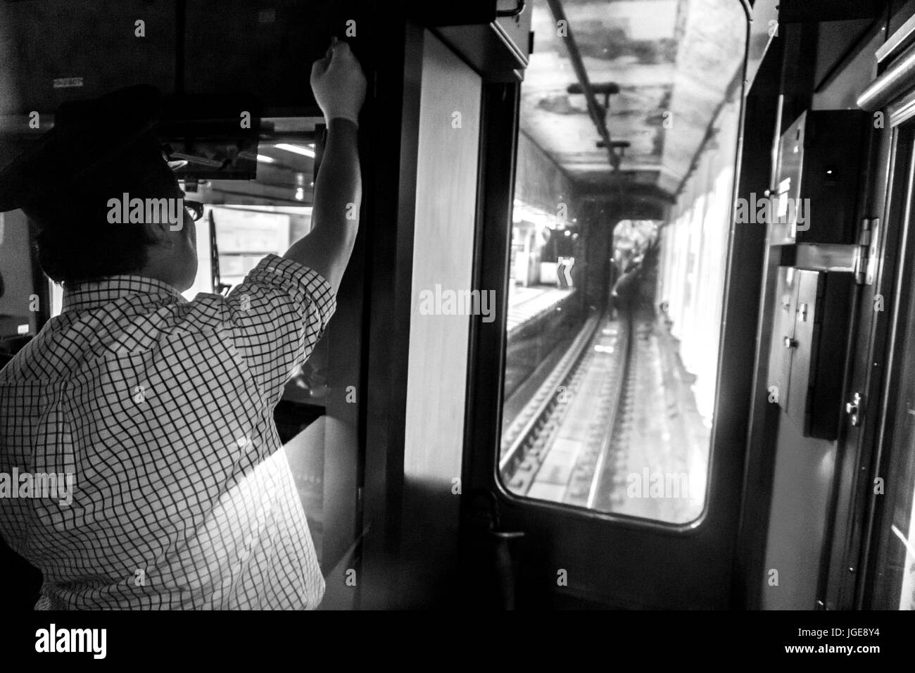 Train conductor driving train towards Shinjuku area on the Odakyu line, Tokyo, Japan Stock Photo