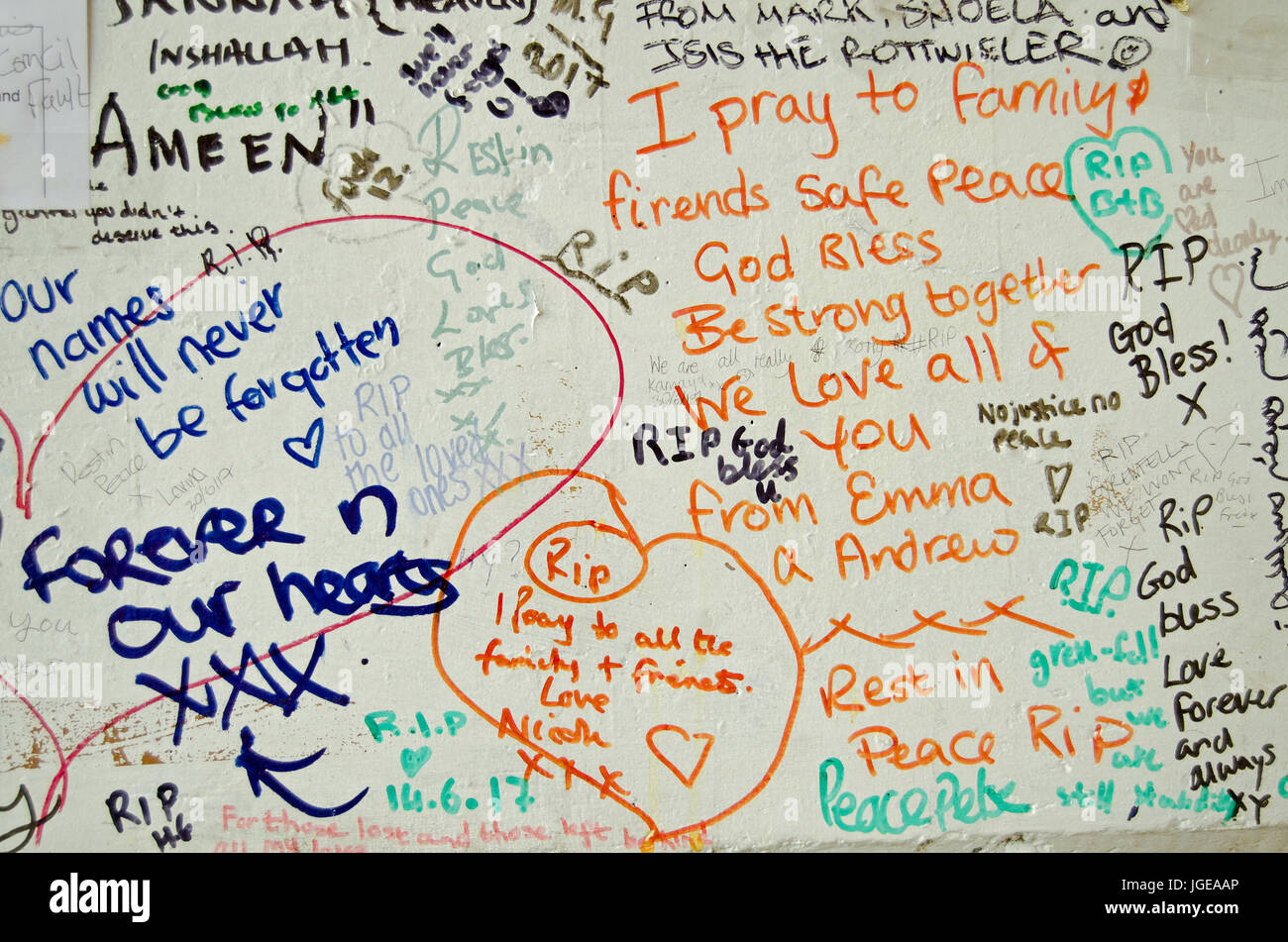 LONDON, UK - JULY 6, 2017:  Memorial messages written on a wall close too the Grenfell Tower block of council flats in which at least 80 people are fe Stock Photo