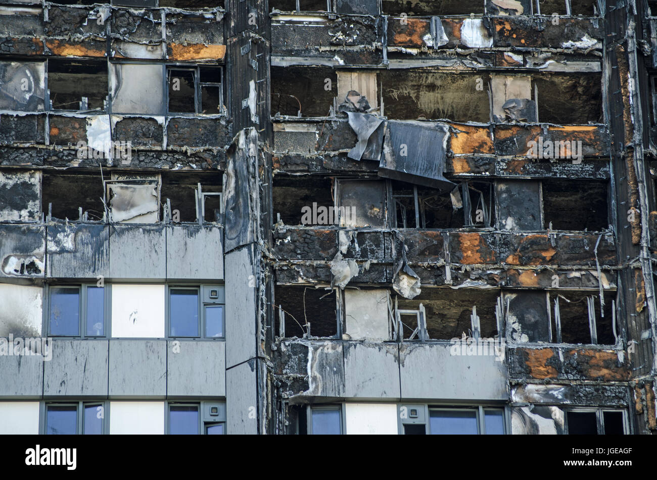Close up view of the exterior of the Grenfell Tower block of flats in which at least 80 people lost their lives in a fire.  Remains of exterior claddi Stock Photo
