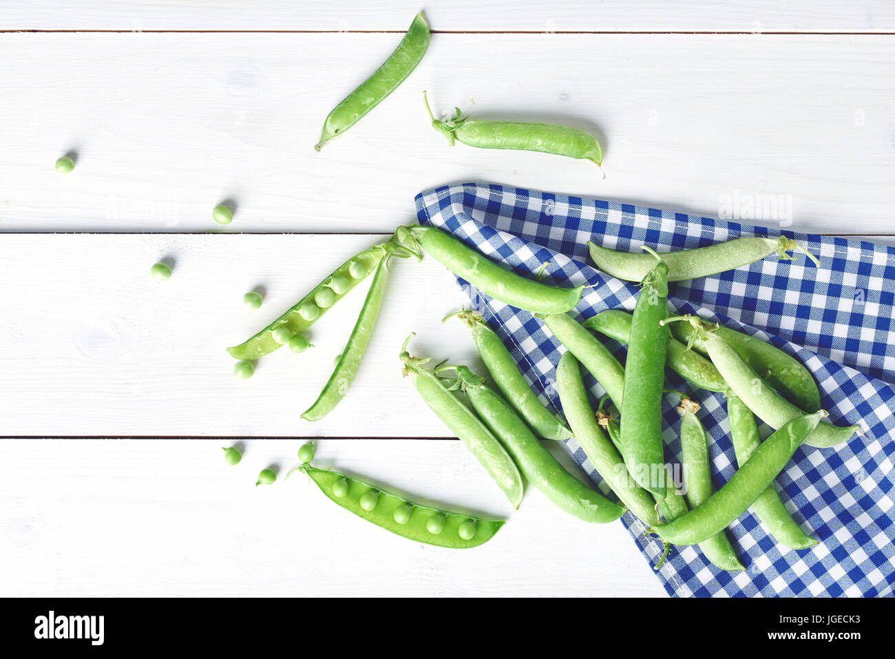 Green peas on the white wooden desks Stock Photo