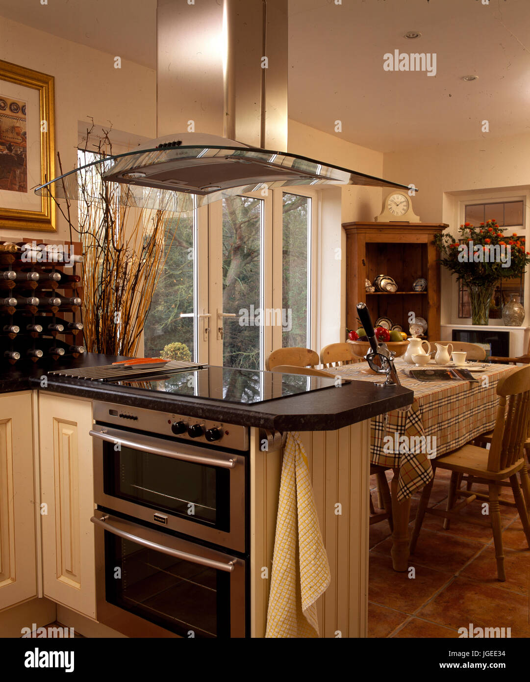 Hob and ovens in peninsular unit used as divider in this kitchen Stock Photo
