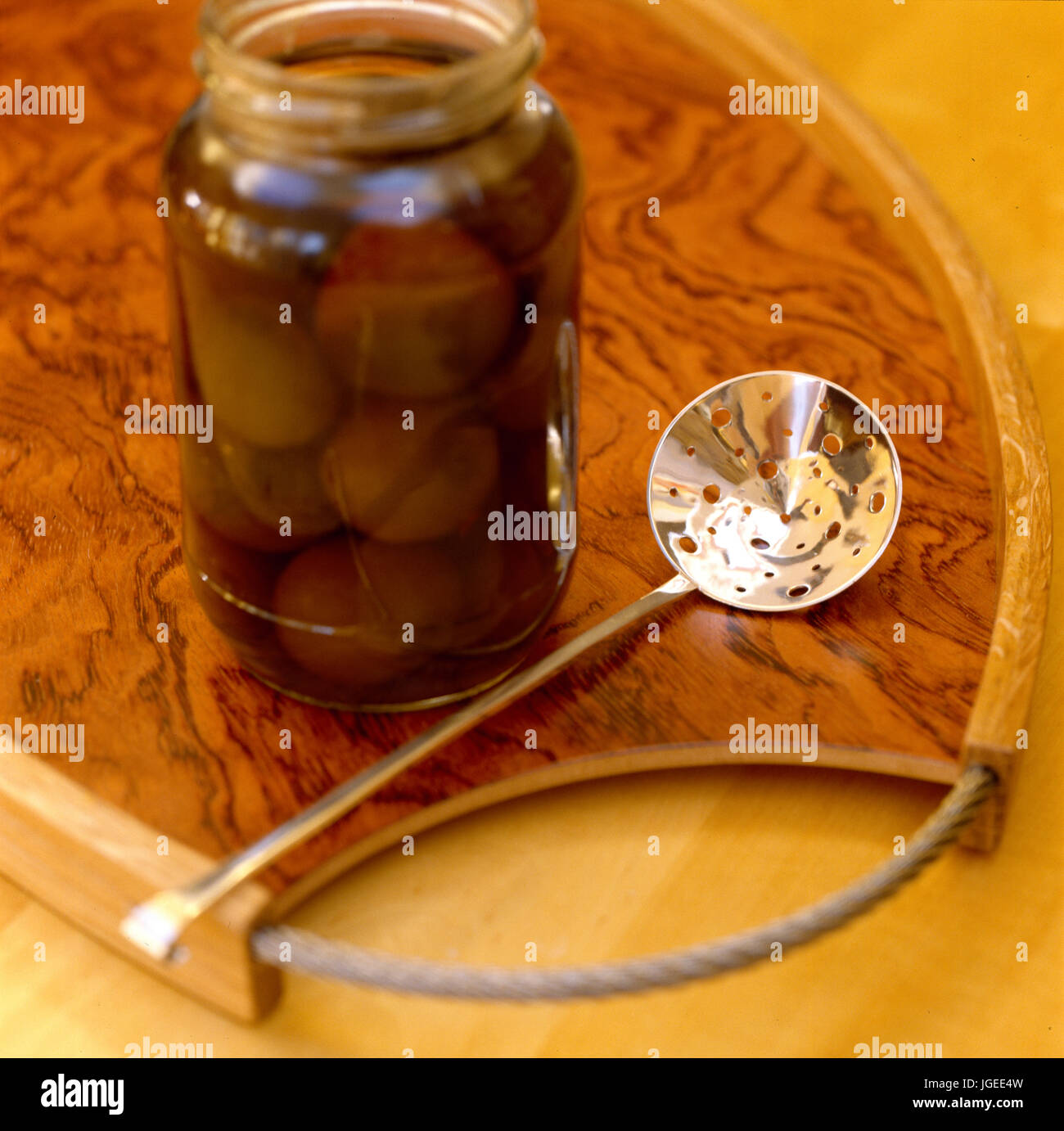 Pickled onions in jar with small silver laddle Stock Photo Alamy