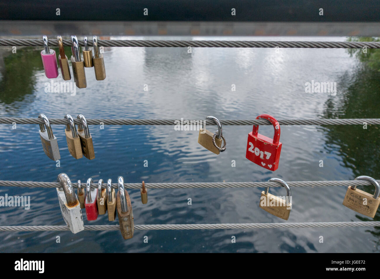 Padlocks on the side of a bridge, safety wires Stock Photo Alamy