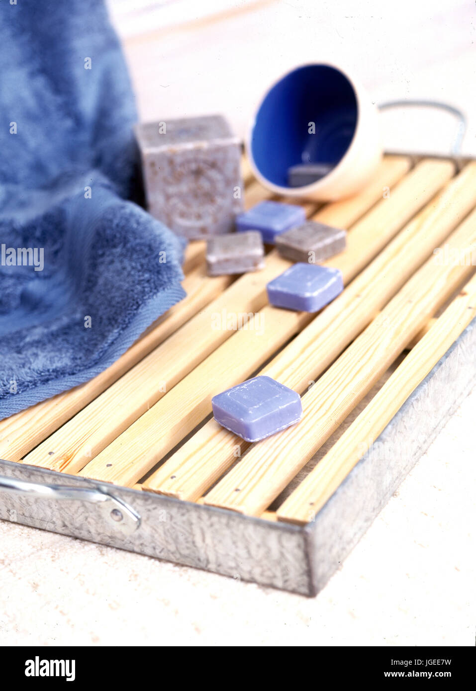 Small Squares Of Scented Soap On Slatted Wood Bathmat Stock Photo