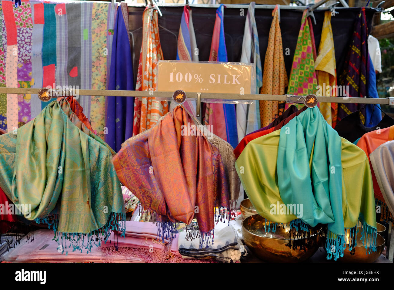 Market stall selling silk items in Spitalfields Market in the East End of London Stock Photo