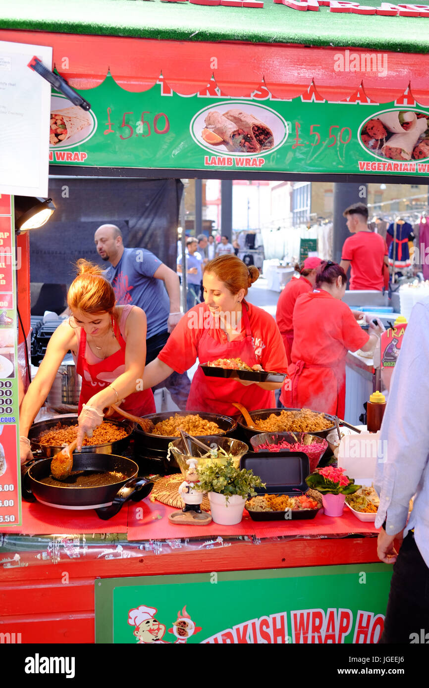 Food stalls at lunch time in Spitalfields Market in London's East End Stock Photo