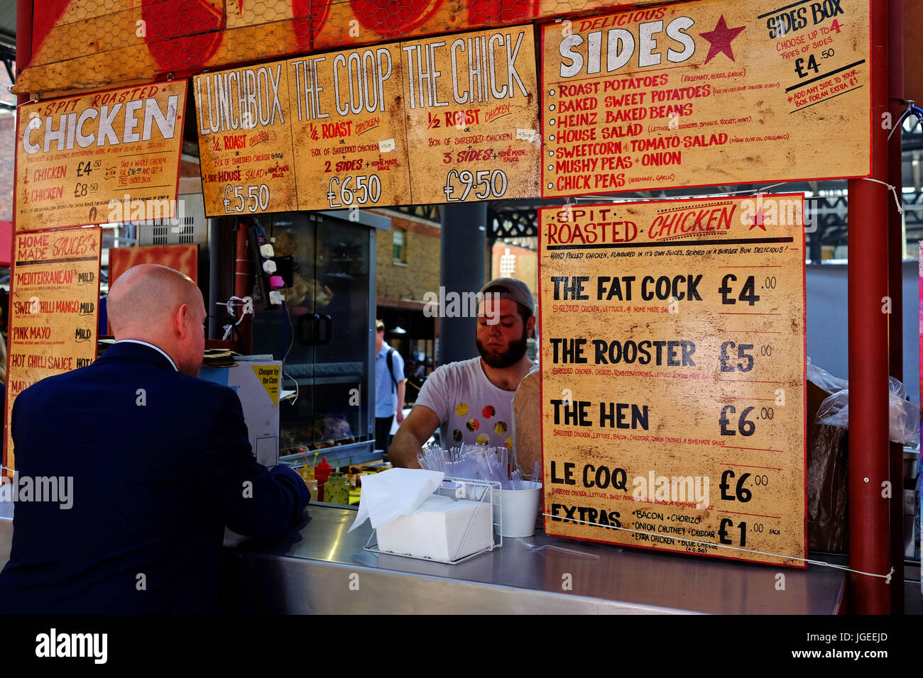 Food stalls at lunch time in Spitalfields Market in London's East End Stock Photo