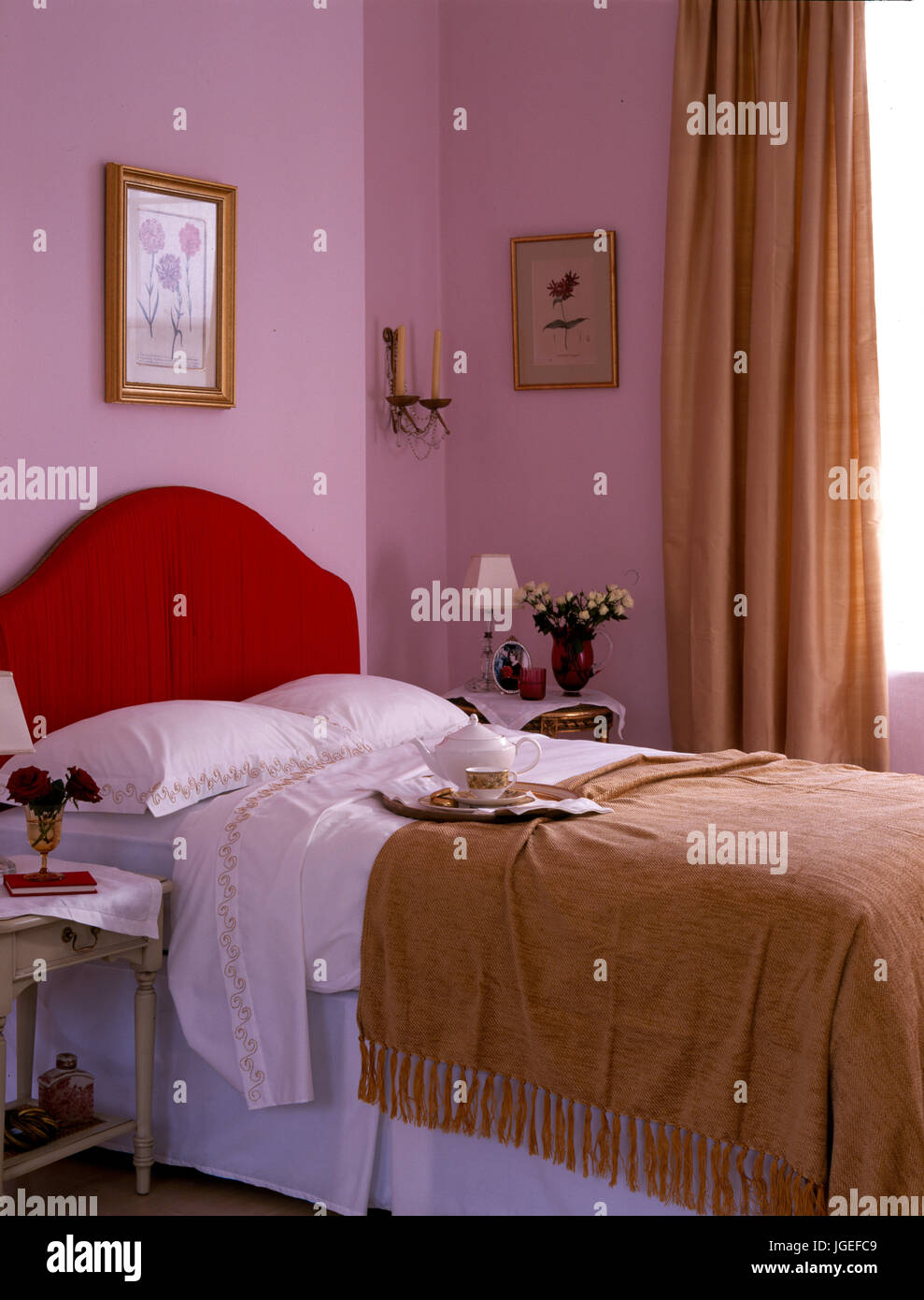 Mauve Bedroom With Small Double Bed With Red Headboard Stock Photo
