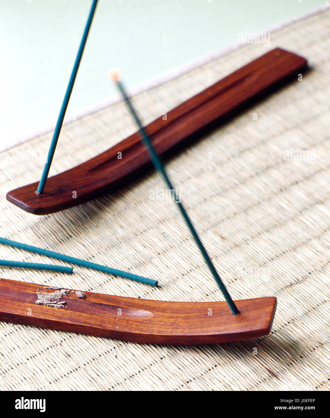 Burning joss sticks in teak holders Stock Photo Alamy