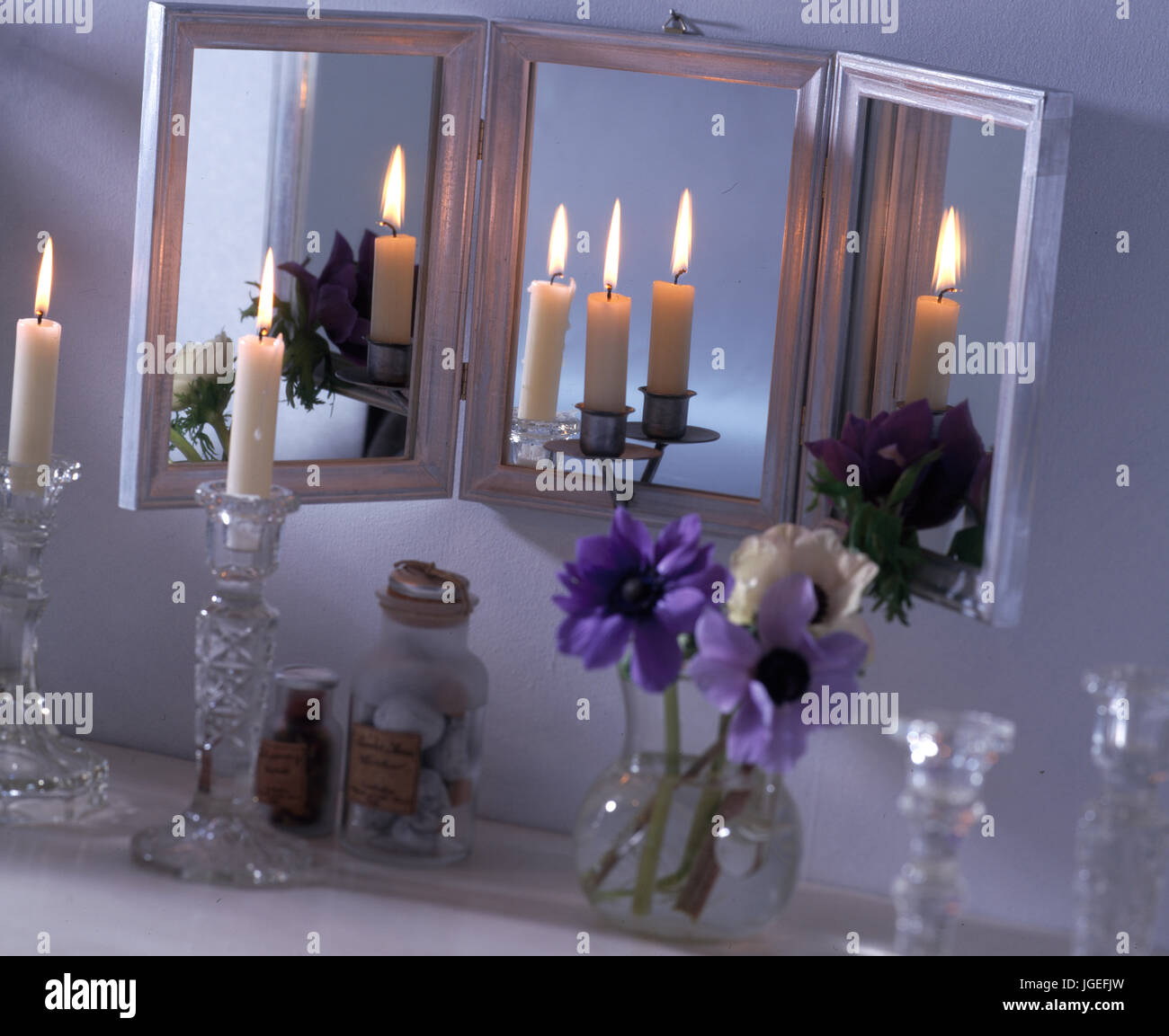 Dressing table with triple mirror, candles & anemones Stock Photo