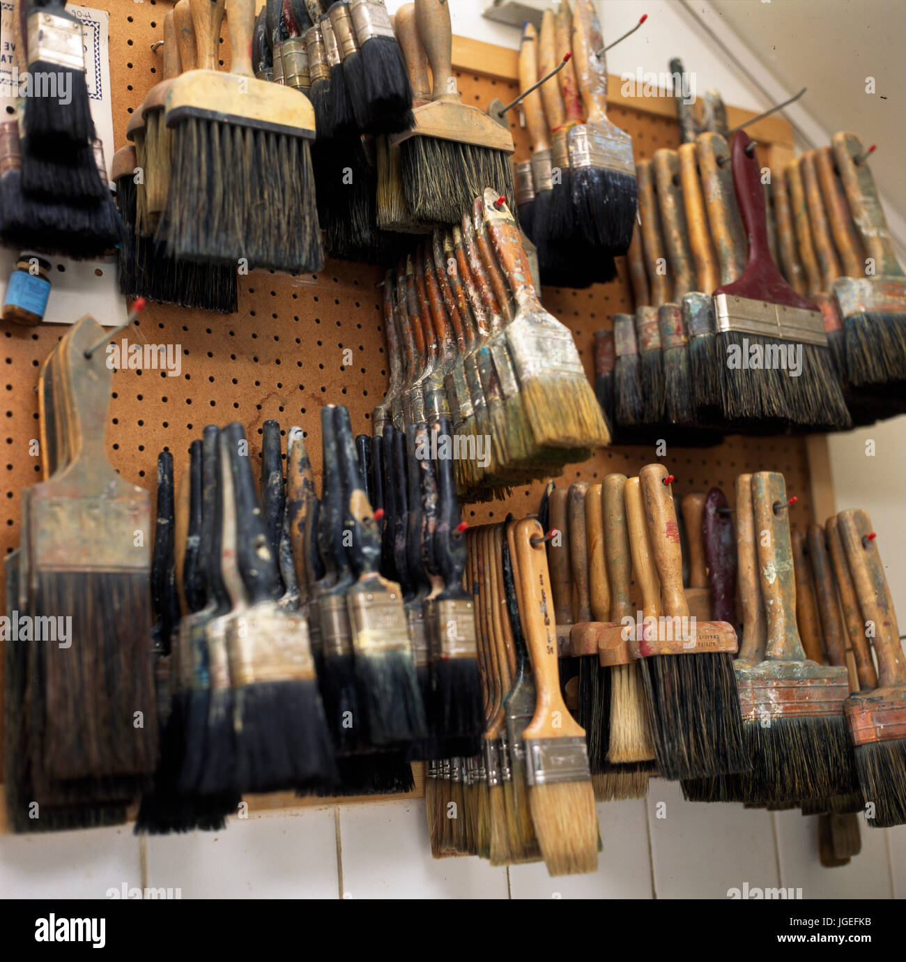 Paint brushes stored on pegboard in shed Stock Photo Alamy