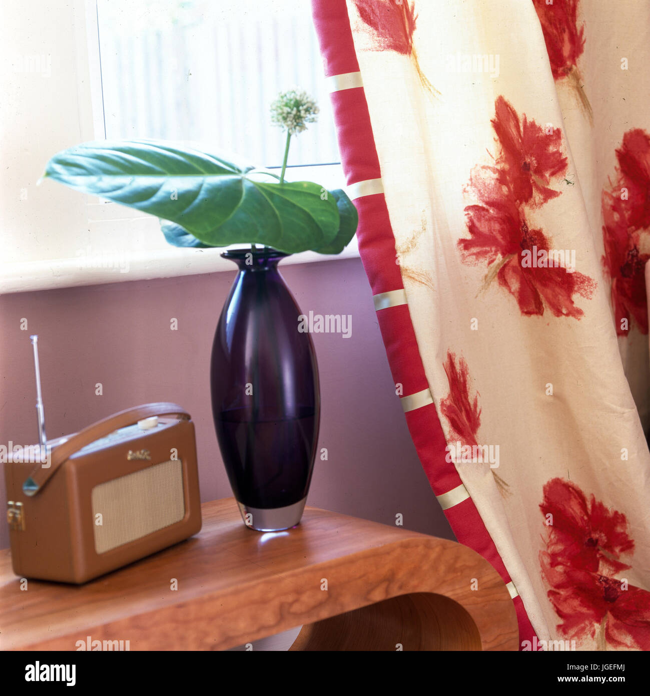 Closeup of Roberts radio and  glasss vase against curtain Stock Photo