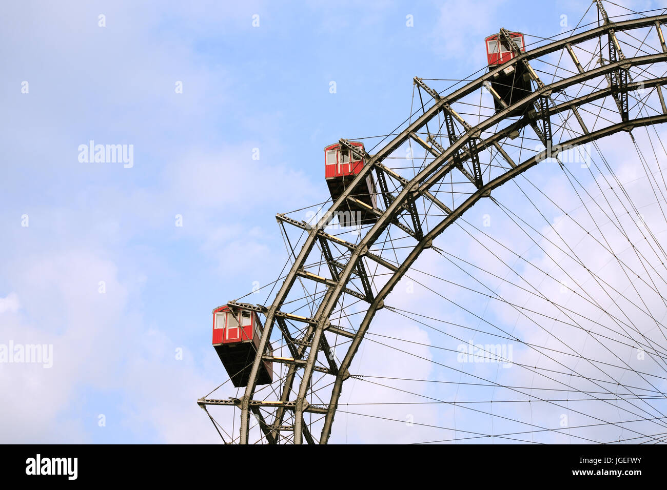 Ferris wheel closeup on background with blue sky and clouds Stock Photo ...