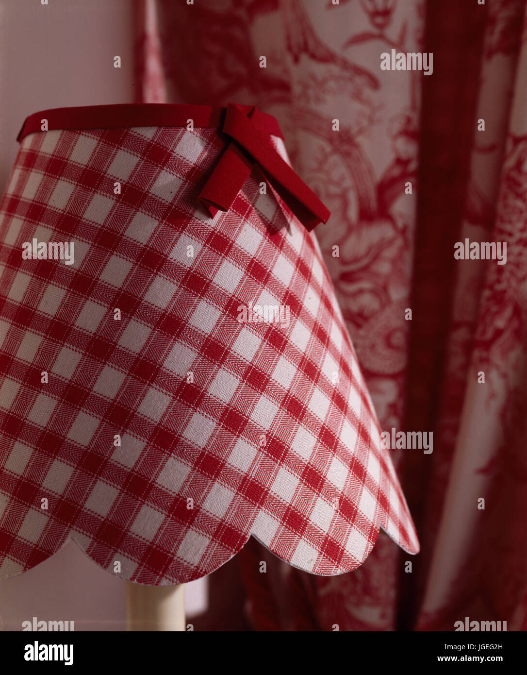 Closeup of red gingham check lamp shade with red bow trim Stock Photo