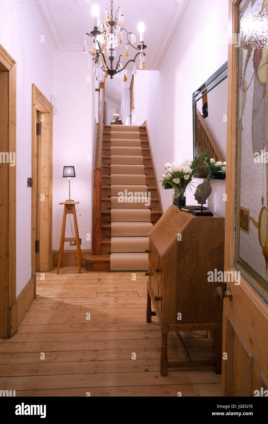 Hall With Striped Pine Boards And Staircase With Sisal Runner
