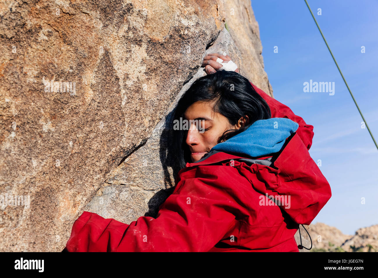 South asian young woman rock climbing in the desert Stock Photo