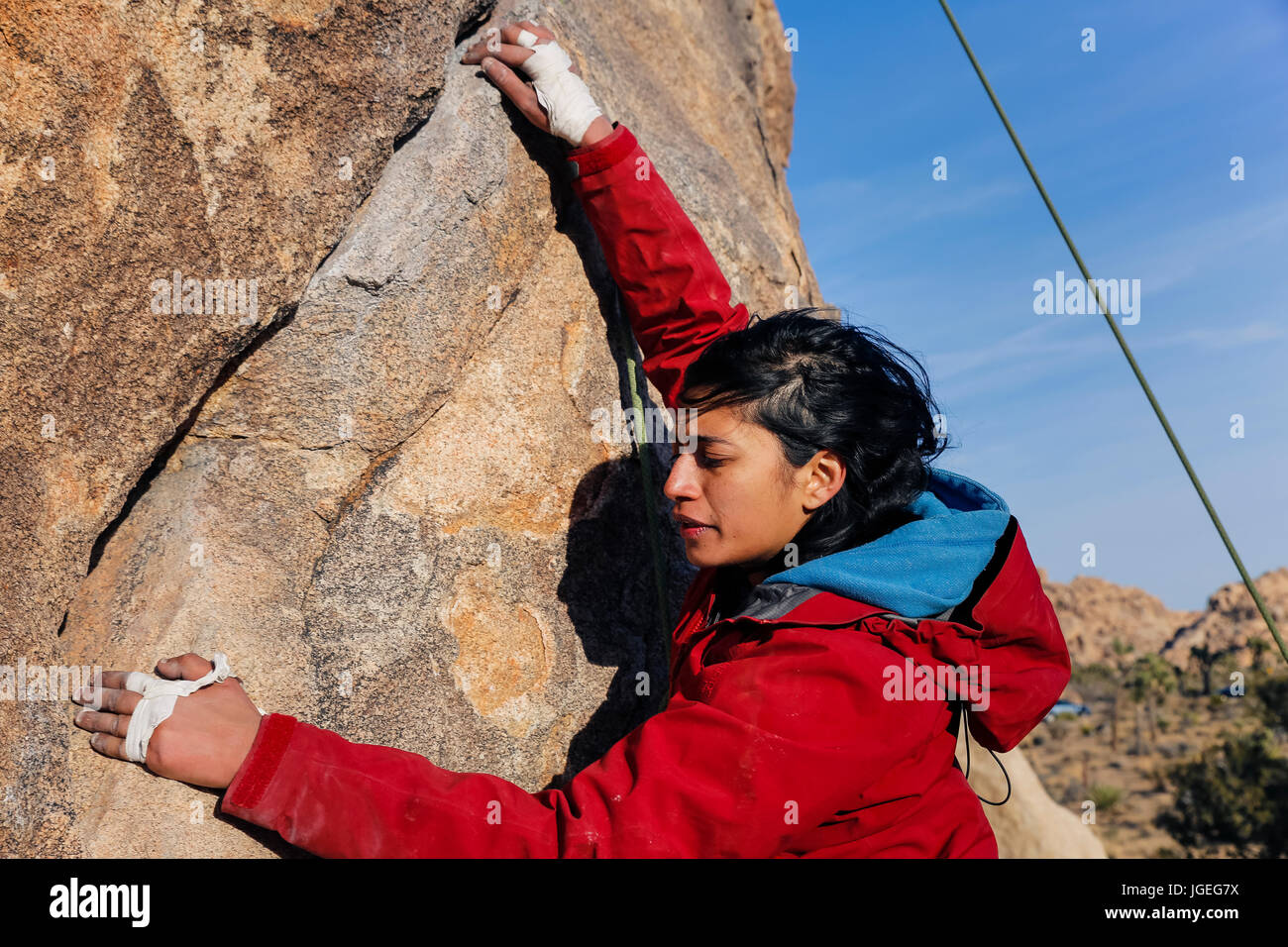 South asian young woman rock climbing in the desert Stock Photo - Alamy