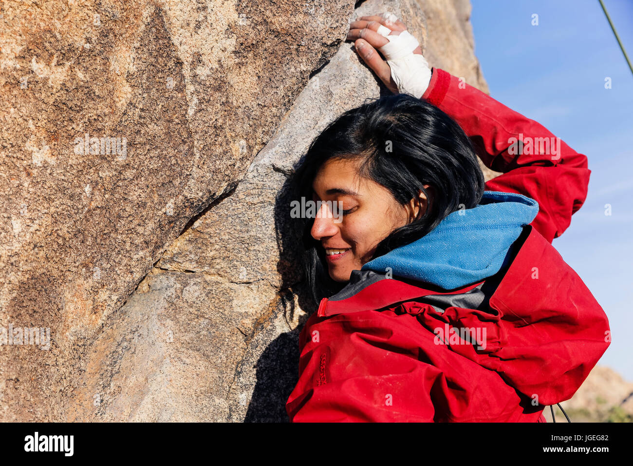 South asian young woman rock climbing in the desert Stock Photo - Alamy