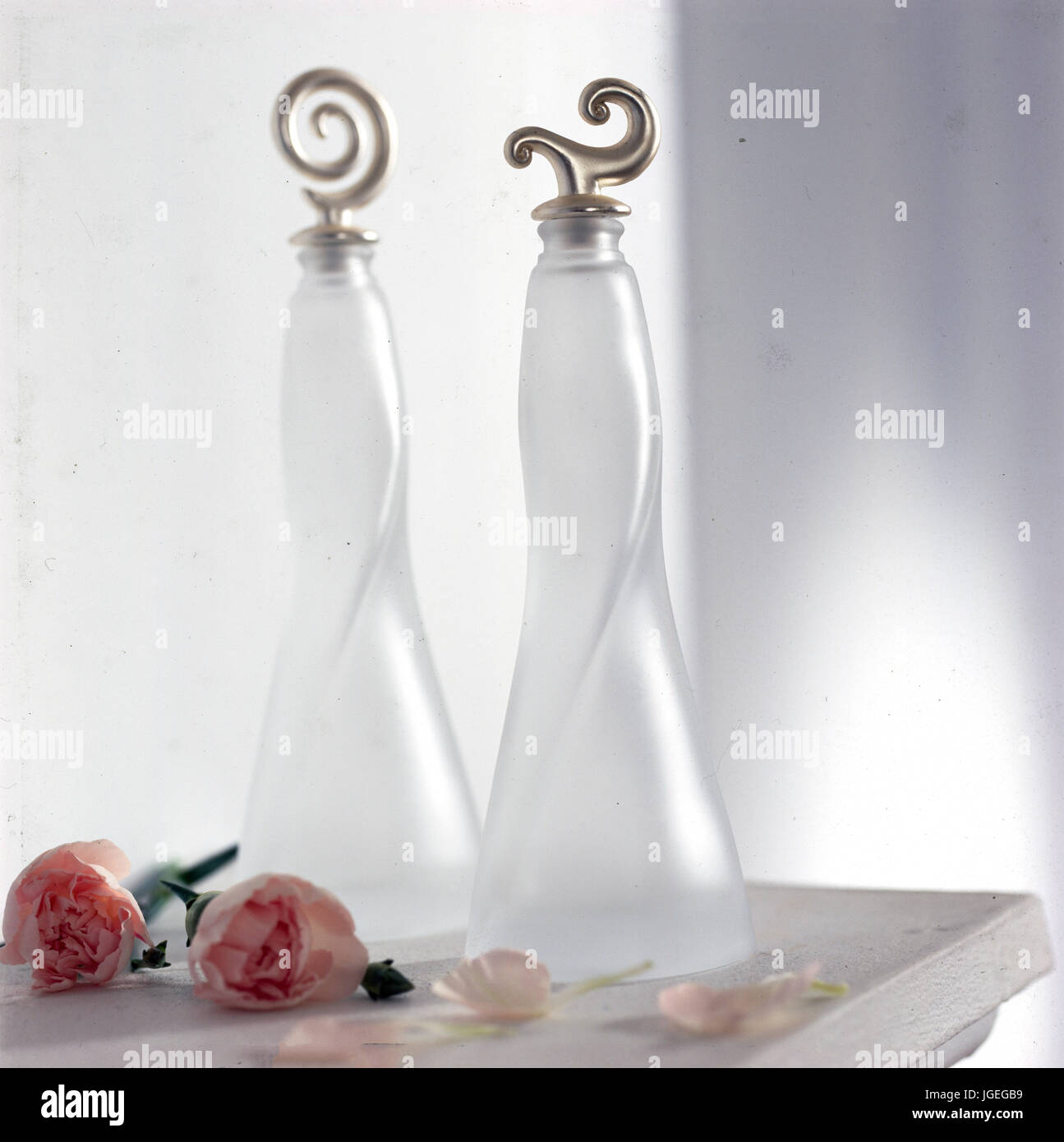 Modern clear glass bottles with silver stoppers Stock Photo