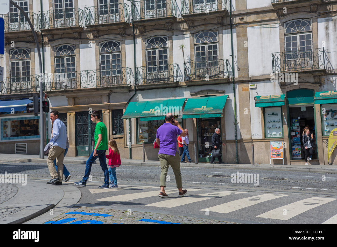 PORTO, PORTUGAL - April 17, 2017: People walking at Old Town street of Porto. Porto is the famous tourist destiantion in Portugal Stock Photo