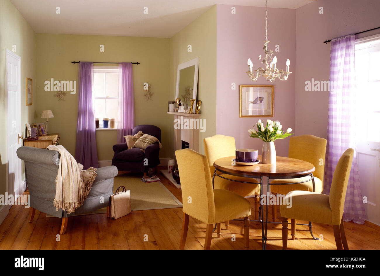 Mauve and green L-shaped living and dining space Stock Photo