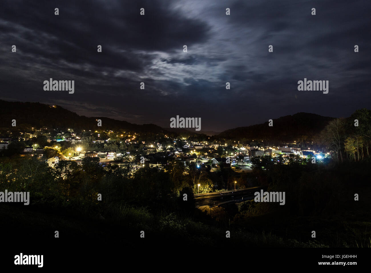 A rural town situated in a valley at night. Stock Photo