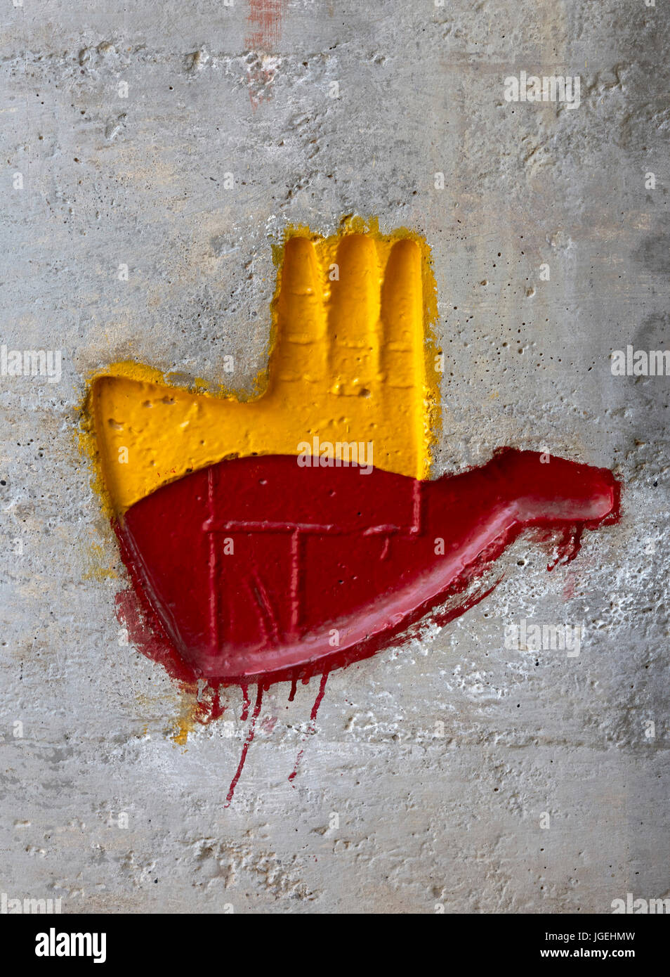 Painted  'open hand symbol' stamped onto concrete wall. Chandigarh College of Architecture, Chandigarh, India. Architect: Corbusier , 1961. Stock Photo