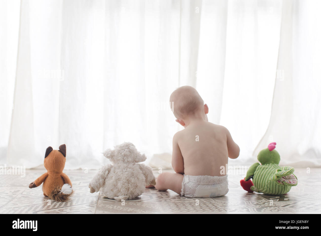 Infant child with plush toys on a white background Stock Photo