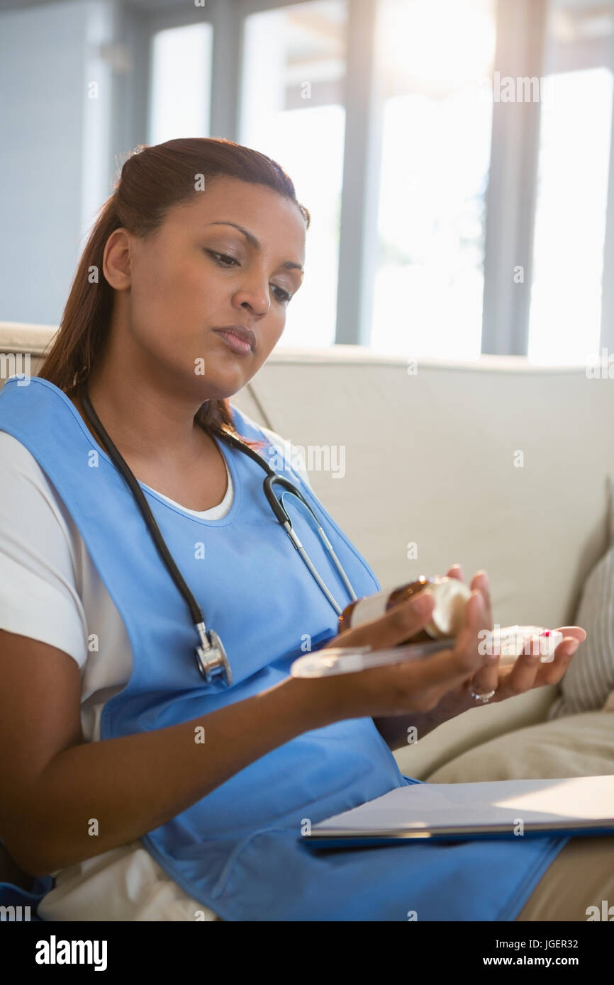 Doctor examining prescription pill bottle in the hospital Stock Photo
