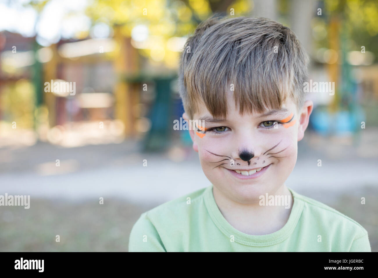 Portrait of cute boy with face paint at playground Stock Photo