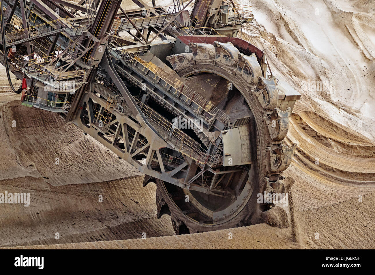 Bucket-wheel excavator mining in a brown coal open pit mine. Stock Photo