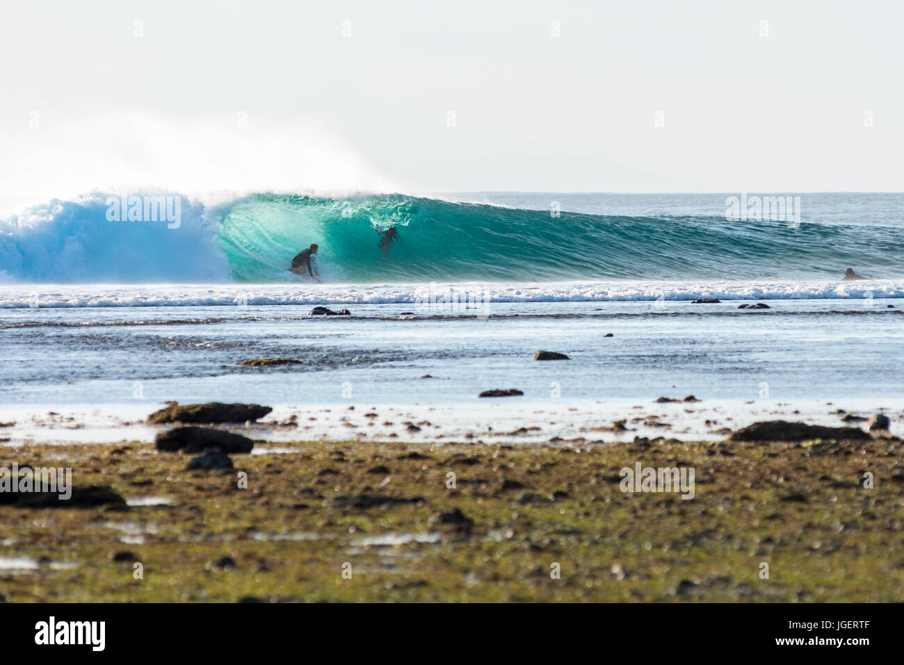 7th June 2017; Desert Point, Lombok, Indonesia.; Surfers from around the world enjoy the extreme swell of tube waves at this remote world class surf s Stock Photo