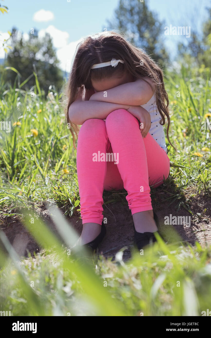 Sad girl sitting grass hi-res stock photography and images - Alamy