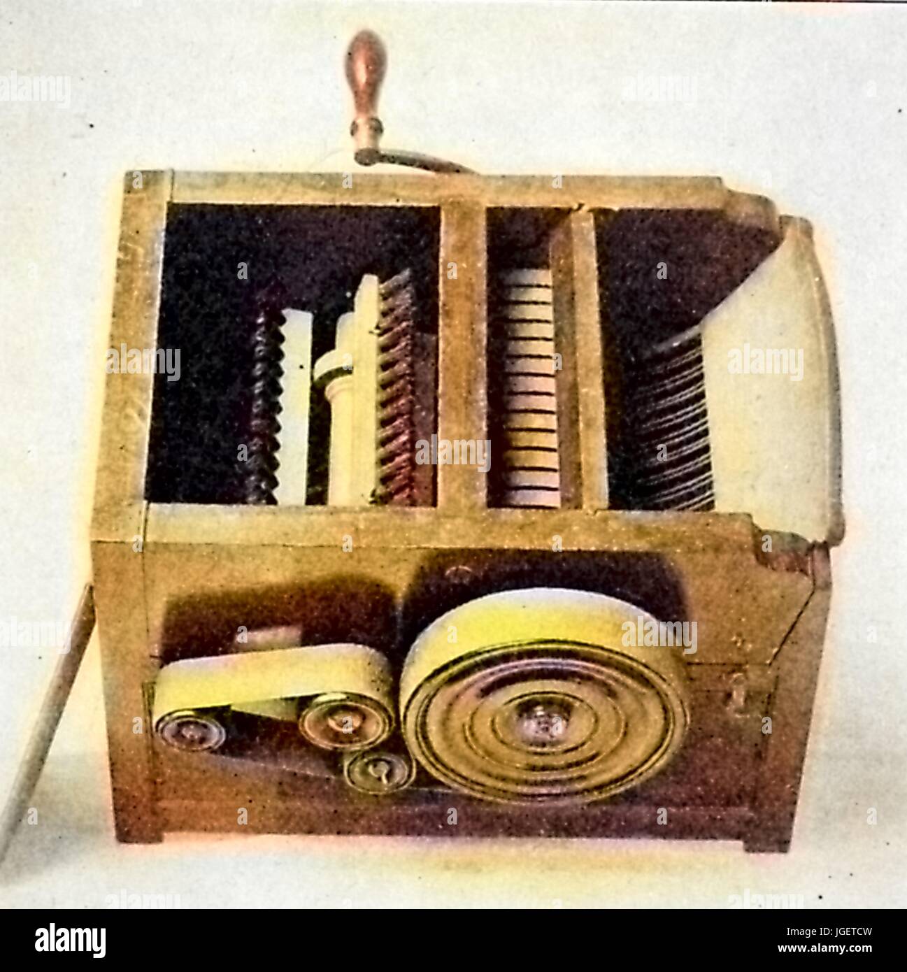 Engraving of a design for a compact cotton gin, with a crank and belt drive mechanism, 1916. Note: Image has been digitally colorized using a modern process. Colors may not be period-accurate. Stock Photo