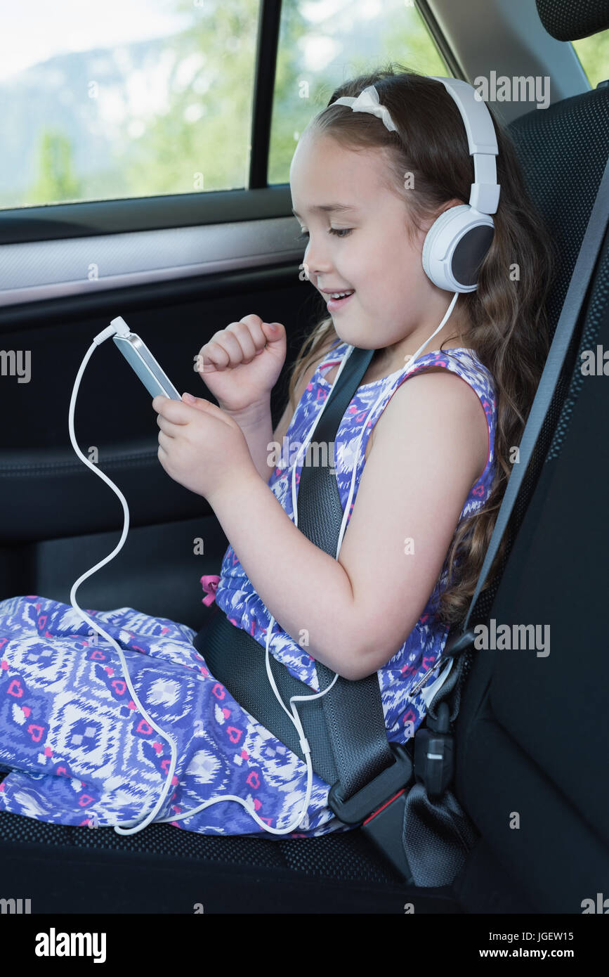 Girl listening music on mobile phone in car Stock Photo Alamy
